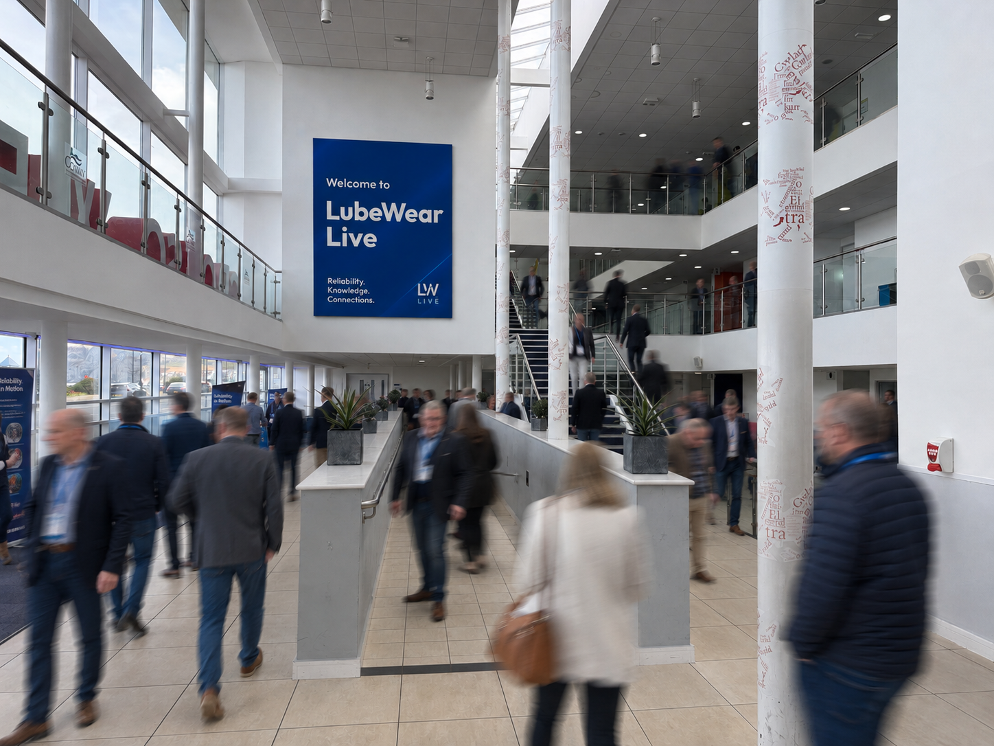 Delegates arriving in the venue atrium beneath the LubeWear Live welcome banner