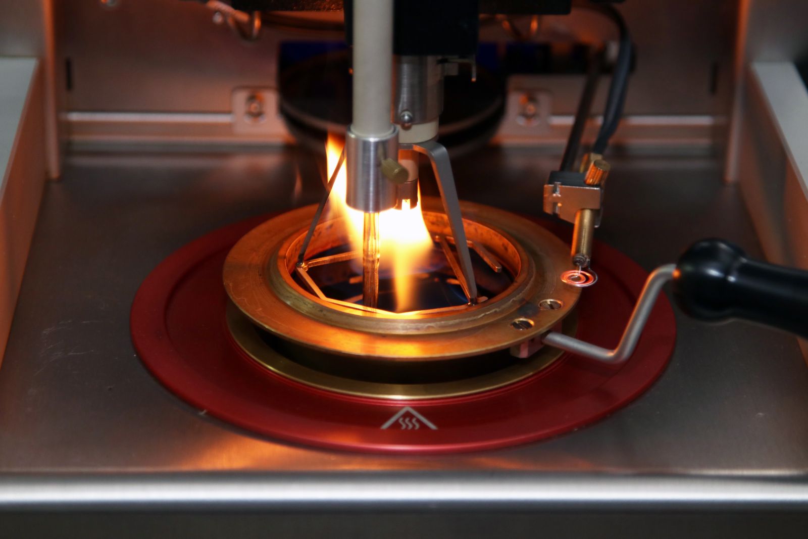 Flash point testing in action — flame passing over a heated oil sample